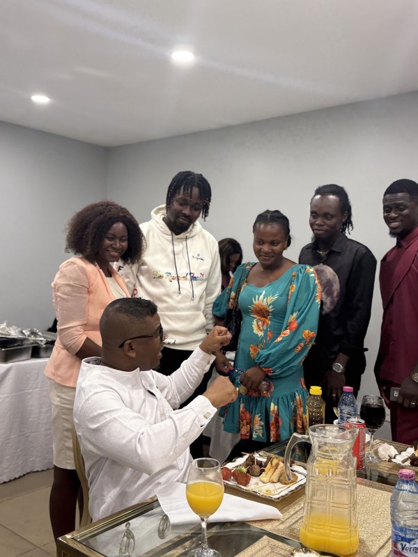 Members greeting one another at a fellowship table