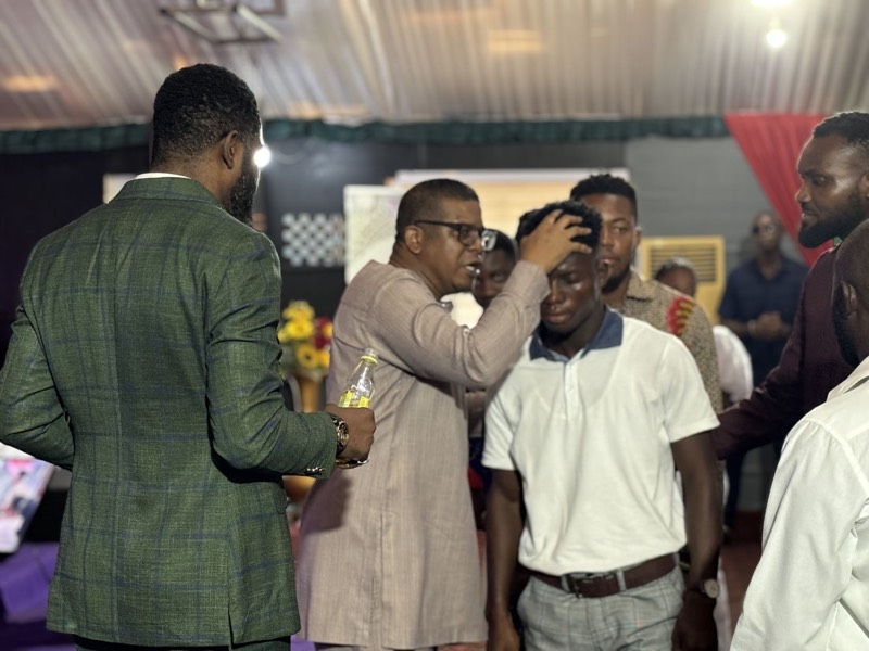 Ministers praying with the laying on of hands