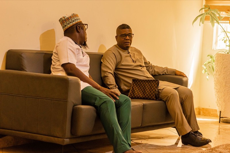Two men in conversation on a sofa