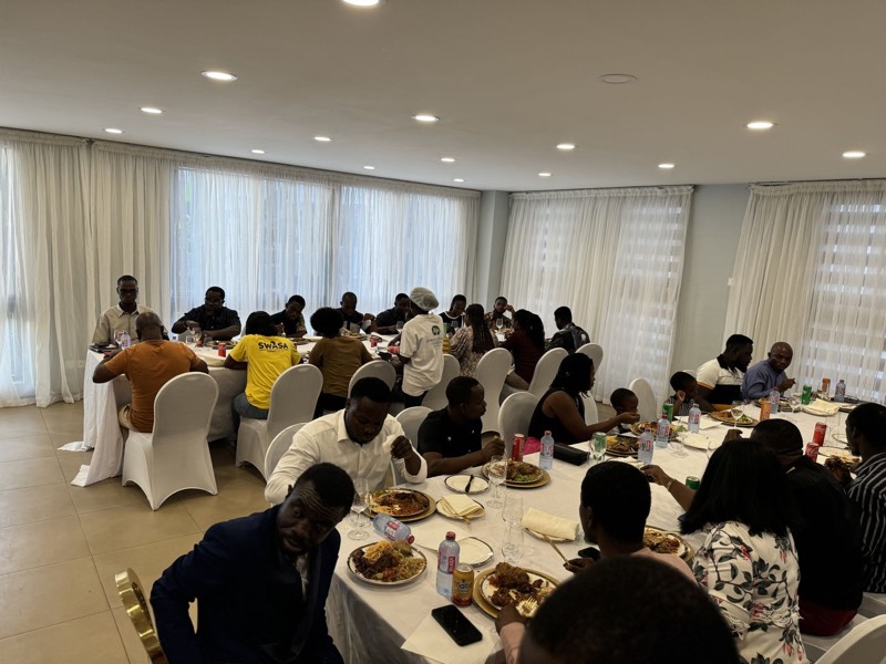 Many people seated at banquet tables