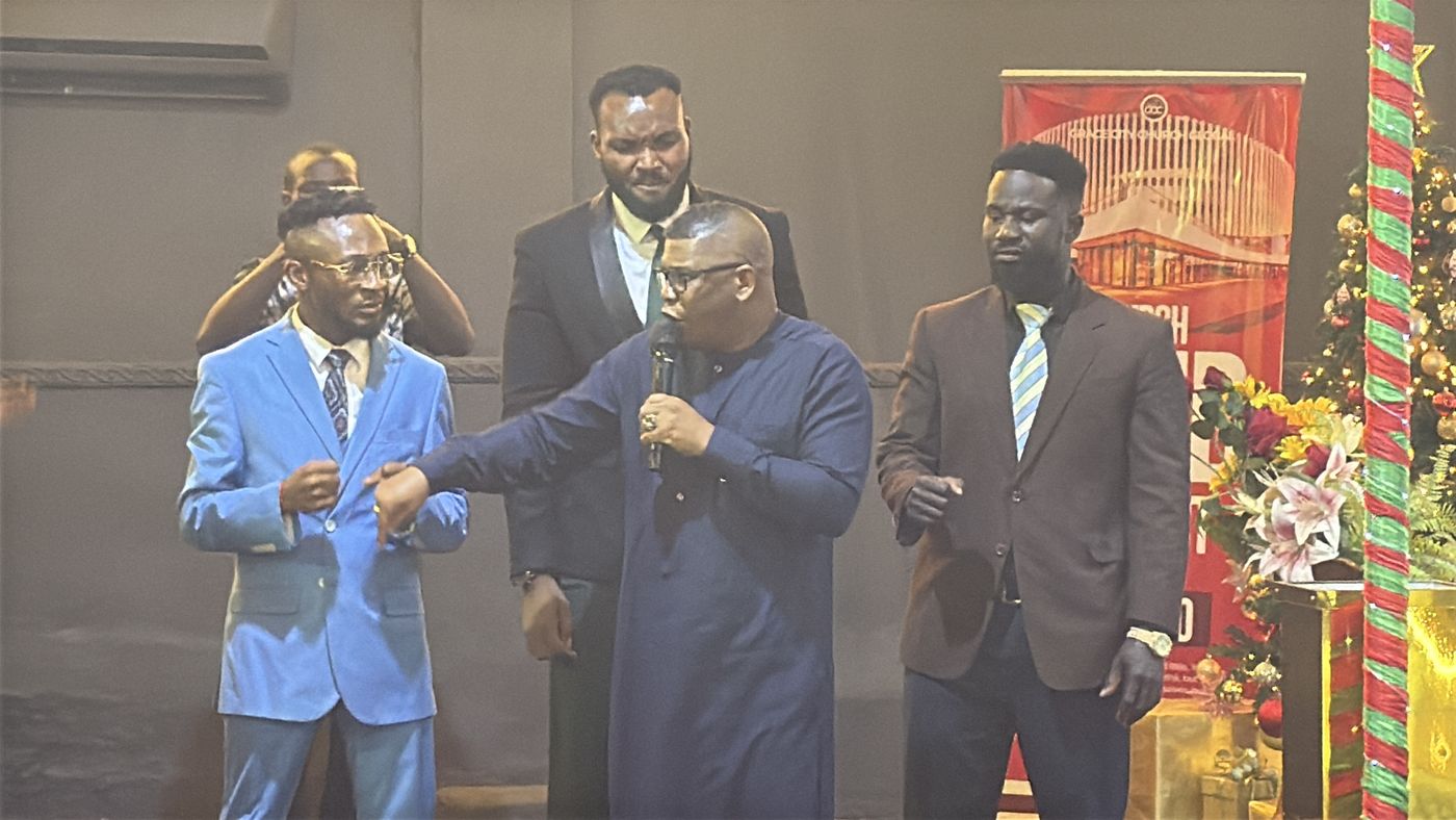 Ministers on a stage praying together